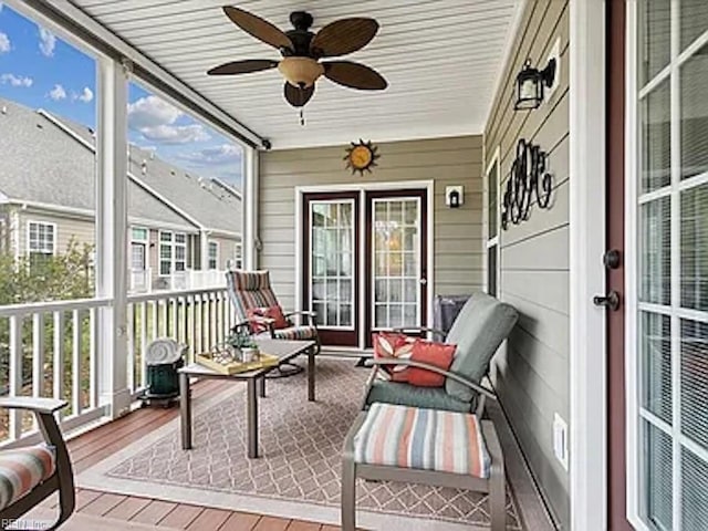 sunroom featuring ceiling fan