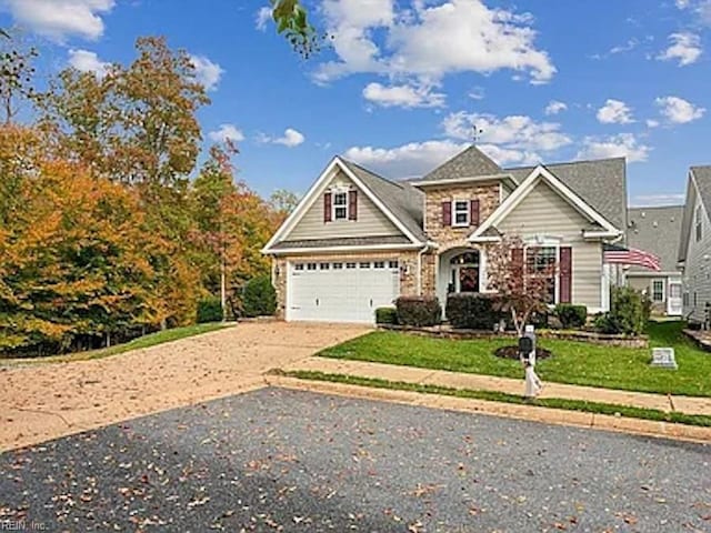 view of front of home featuring a garage and a front yard