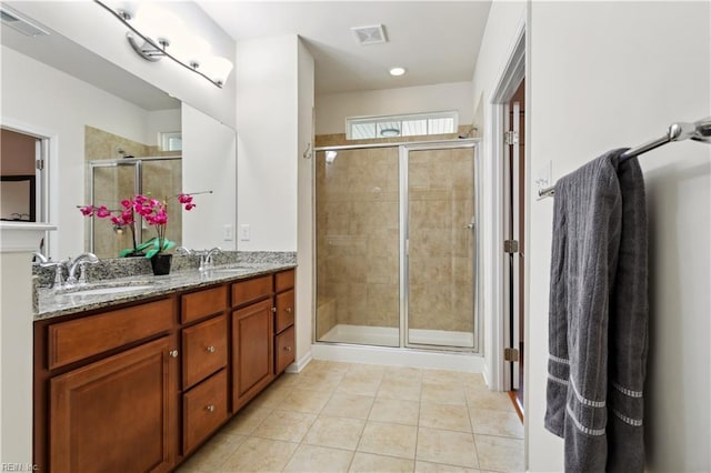 bathroom featuring an enclosed shower, vanity, and tile patterned flooring