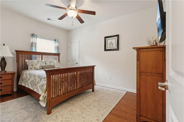 bedroom featuring ceiling fan and dark hardwood / wood-style floors