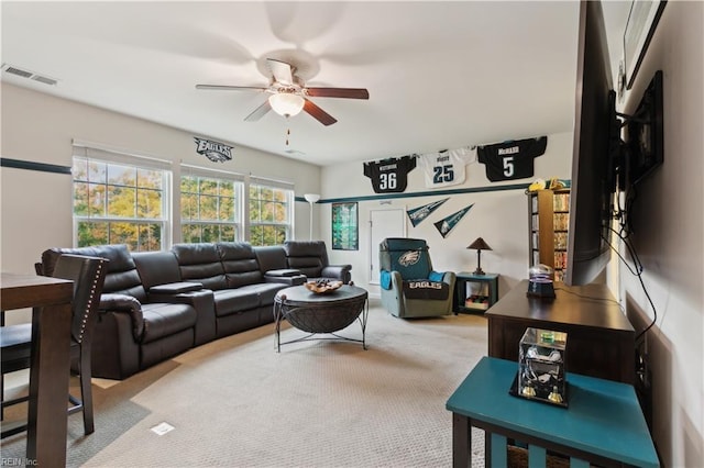 living room featuring light carpet and ceiling fan