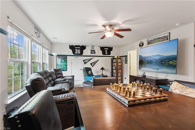 living room featuring ceiling fan and a healthy amount of sunlight