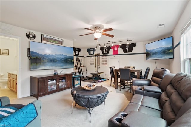 living room with light carpet, ceiling fan, and rail lighting