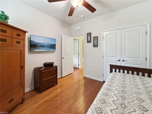 bedroom with ceiling fan, a closet, and wood-type flooring