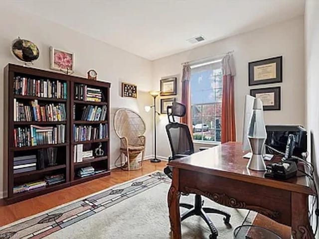 office space with wood-type flooring