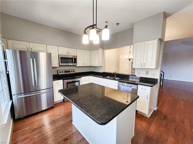 kitchen featuring a kitchen island, stainless steel appliances, and white cabinetry