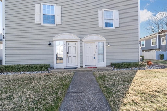 doorway to property featuring a yard