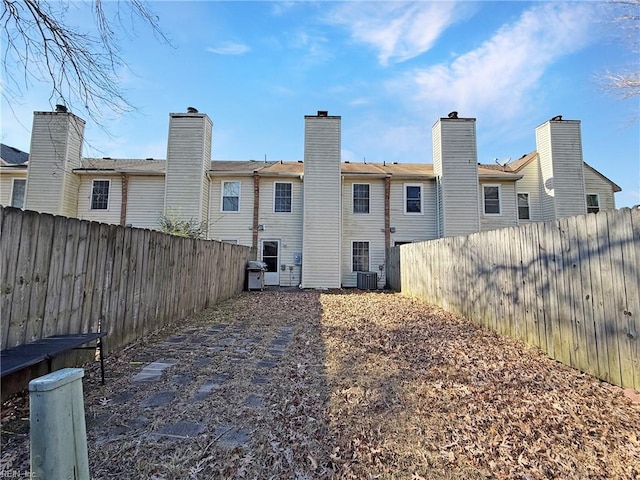 back of house featuring central AC