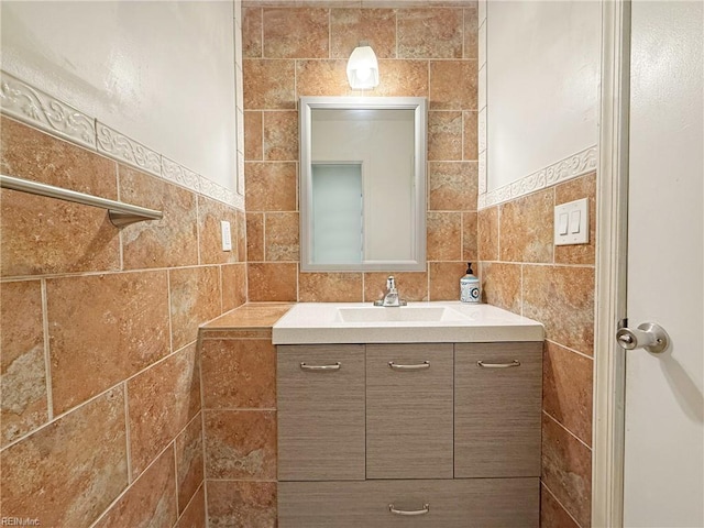 bathroom featuring tile walls and vanity