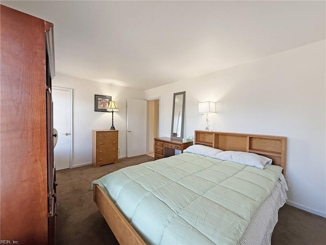 bedroom with dark colored carpet