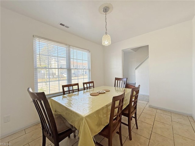 dining space featuring light tile patterned flooring