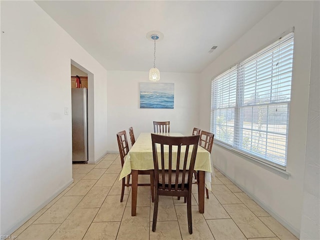 dining area featuring light tile patterned flooring