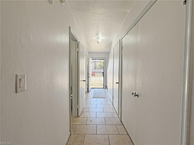 corridor with light tile patterned floors