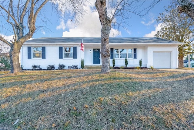 single story home featuring a front lawn and a garage