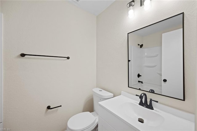 full bathroom featuring toilet, vanity, and bathtub / shower combination