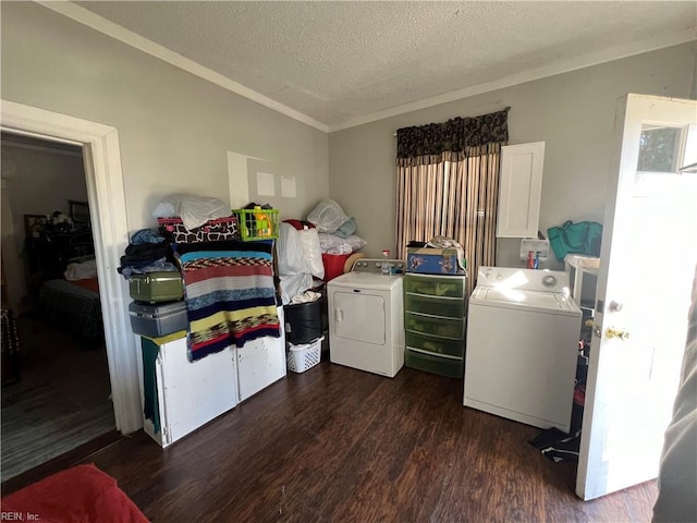 clothes washing area with separate washer and dryer, a textured ceiling, and dark hardwood / wood-style floors