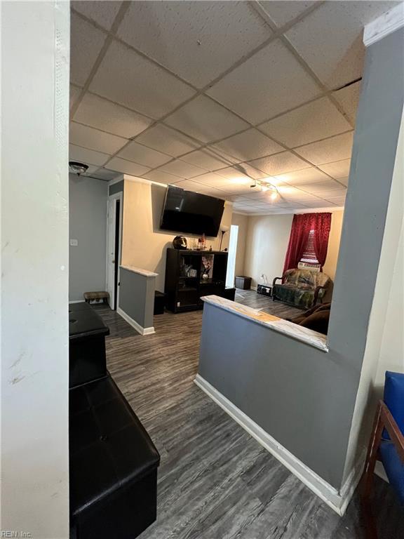 kitchen with dark hardwood / wood-style flooring and a drop ceiling