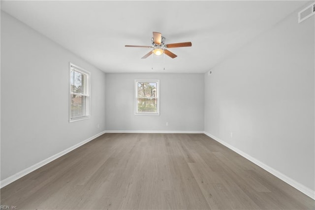 spare room featuring ceiling fan and hardwood / wood-style floors