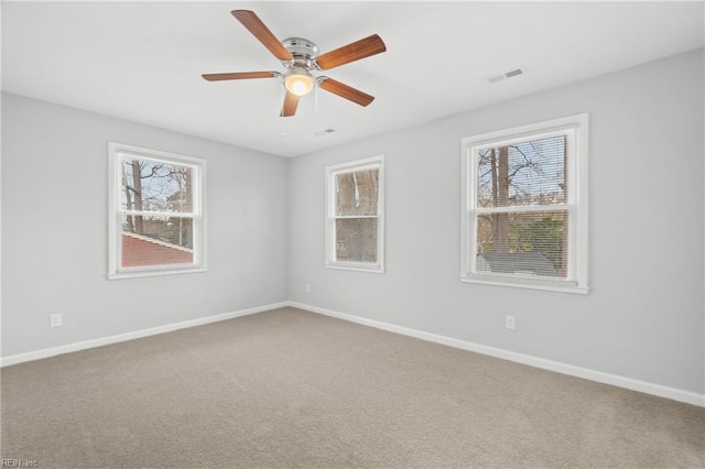 empty room featuring ceiling fan and carpet floors