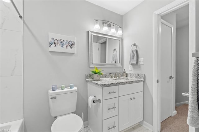 bathroom featuring toilet and vanity