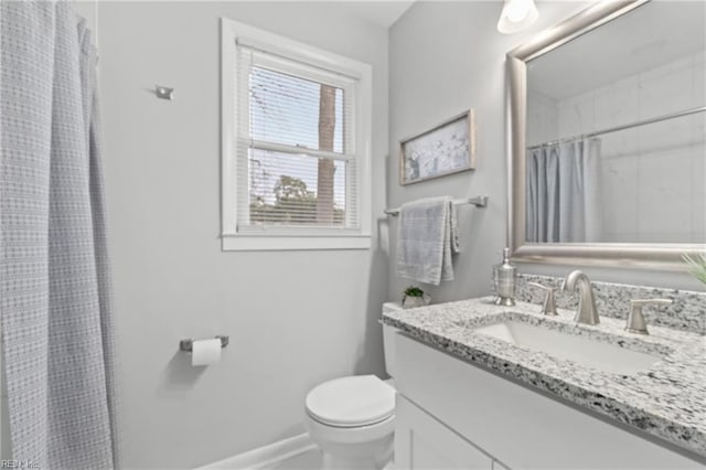 bathroom featuring toilet, a shower with curtain, and vanity