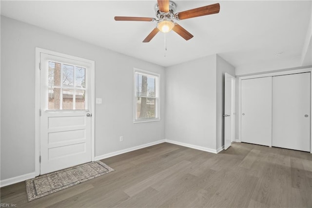 entrance foyer featuring ceiling fan, plenty of natural light, and light hardwood / wood-style flooring