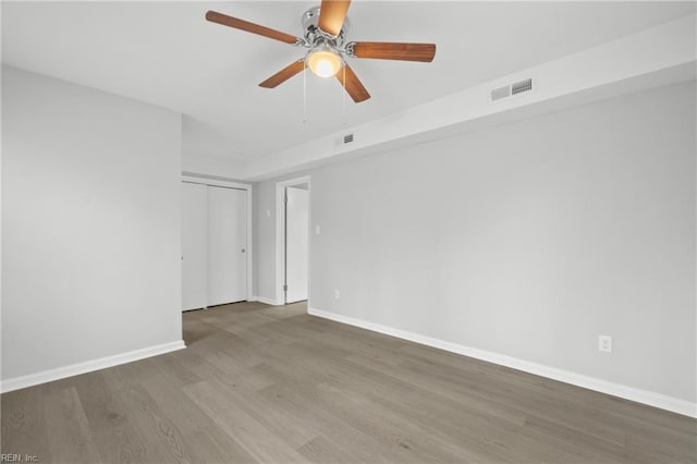 spare room with ceiling fan and wood-type flooring