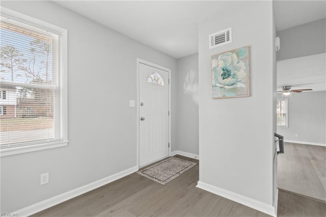 foyer entrance with ceiling fan and hardwood / wood-style floors