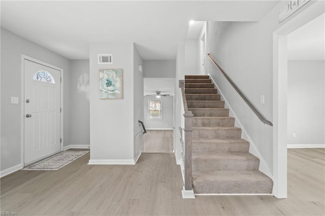 foyer with ceiling fan and light wood-type flooring