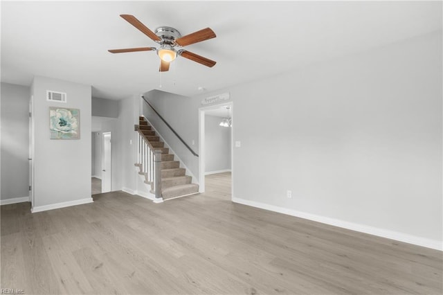 unfurnished living room featuring ceiling fan and light hardwood / wood-style flooring