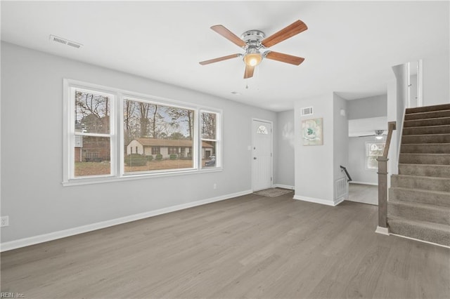 unfurnished living room featuring ceiling fan and hardwood / wood-style floors