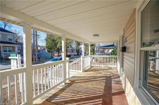 wooden terrace featuring covered porch