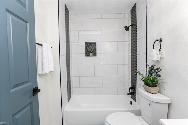 bathroom featuring toilet and tiled shower / bath combo