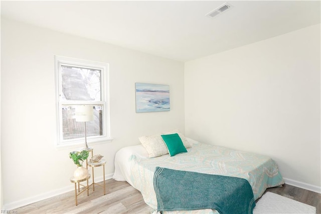 bedroom with hardwood / wood-style floors