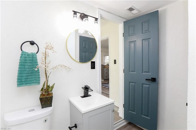 bathroom featuring toilet and vanity