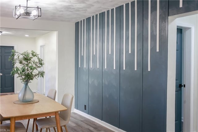 dining room with hardwood / wood-style flooring and a notable chandelier