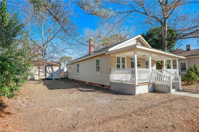 view of front of house featuring a shed and covered porch