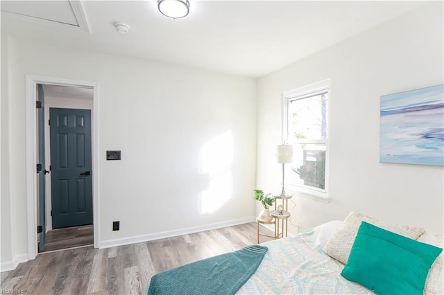 bedroom with hardwood / wood-style flooring