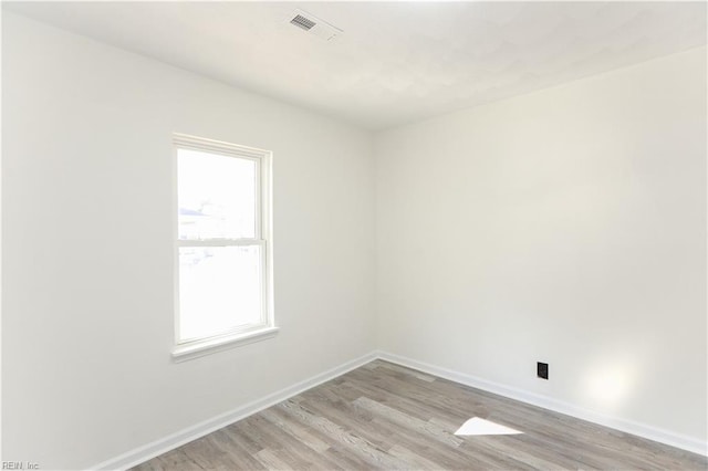 unfurnished room with light hardwood / wood-style flooring and plenty of natural light