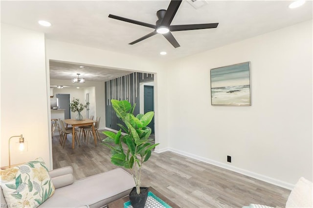 living room with ceiling fan and hardwood / wood-style flooring