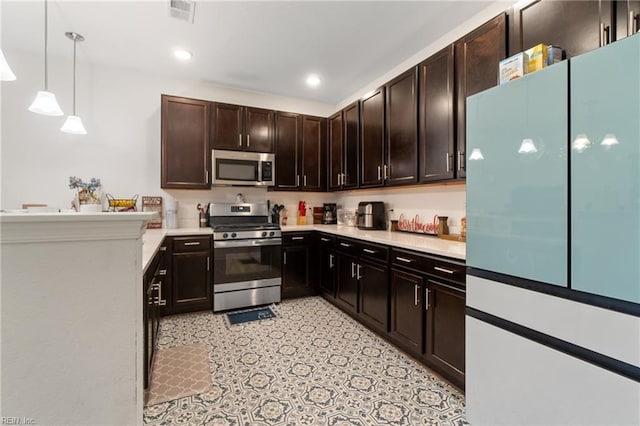 kitchen with hanging light fixtures, dark brown cabinetry, and stainless steel appliances