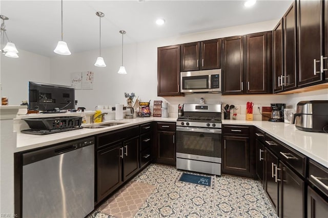 kitchen with sink, hanging light fixtures, appliances with stainless steel finishes, and dark brown cabinets