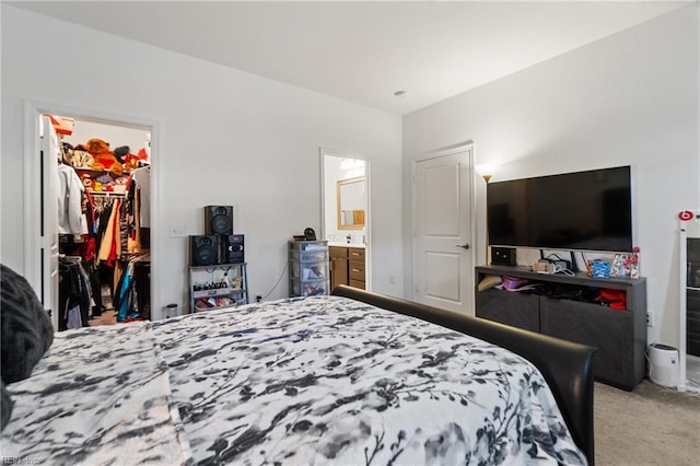 carpeted bedroom with a closet and a walk in closet