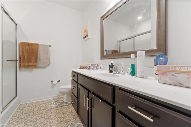 bathroom with a shower with shower door, tile patterned floors, vanity, and toilet