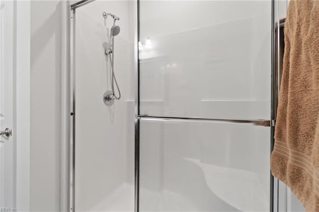 bathroom with a shower with shower door