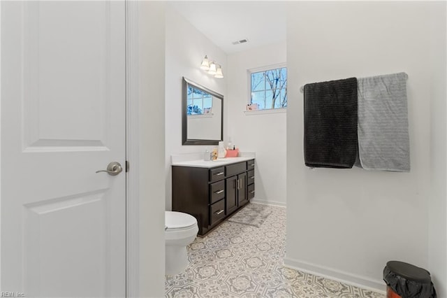 bathroom featuring toilet, tile patterned flooring, and vanity