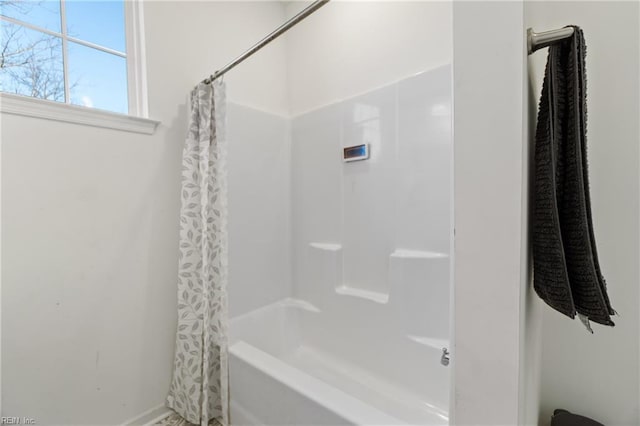 bathroom with shower / bathtub combination with curtain