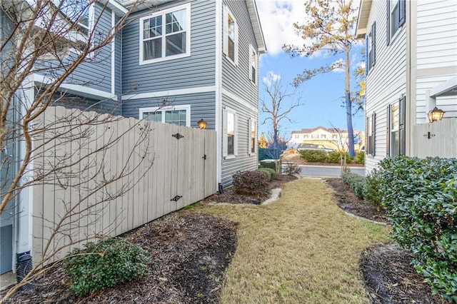 view of side of home featuring a yard