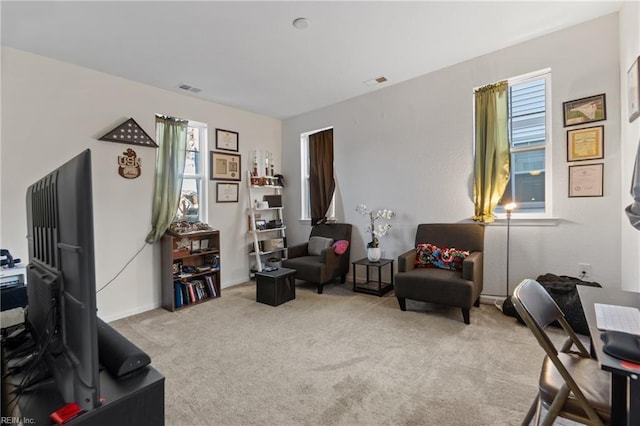 sitting room with light colored carpet