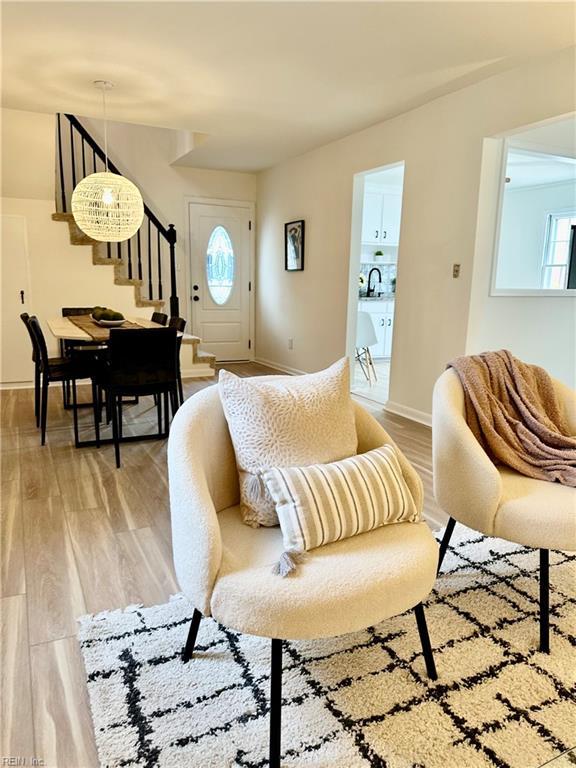 living room featuring light wood-type flooring and a wealth of natural light